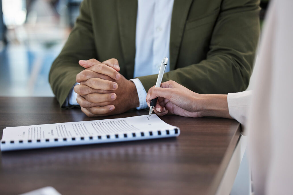 A business lawyer in San Antonio reviewing legal documents with a client, providing expert guidance to protect and strengthen their business.