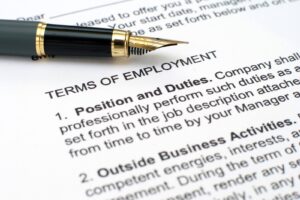 Employment law attorney reviewing legal documents and employment contracts to ensure workplace compliance.
