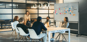 Team meeting in modern office with whiteboard.