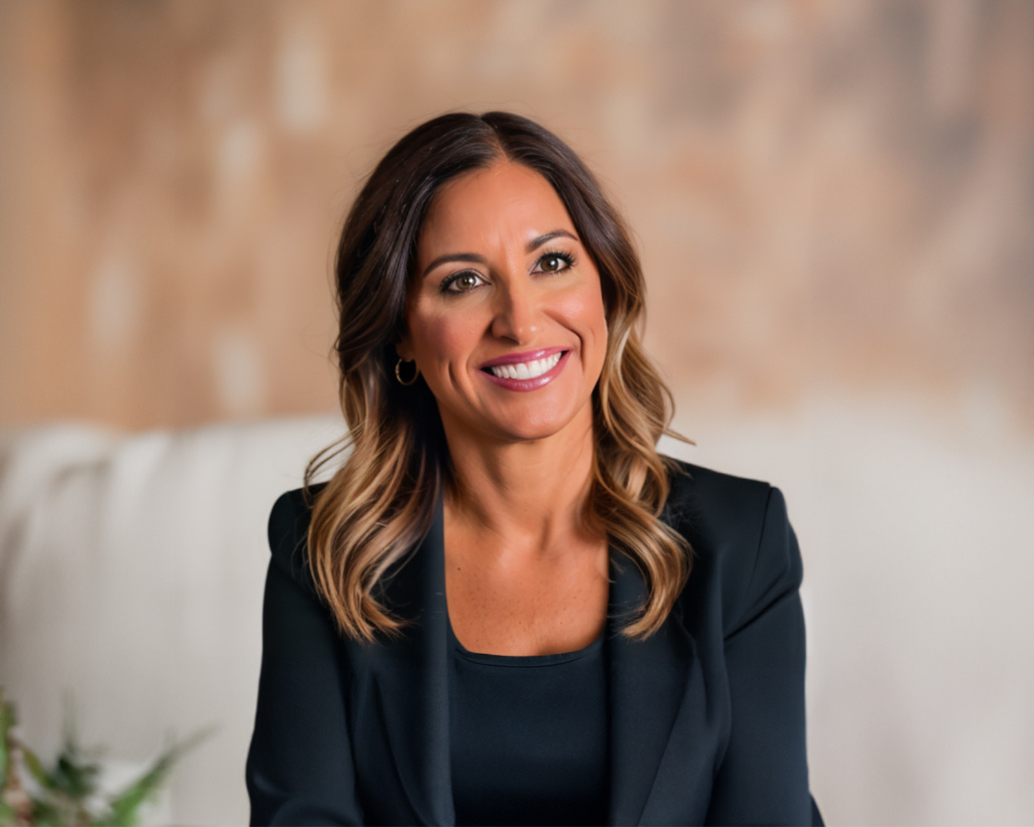 Smiling professional woman in black blazer.