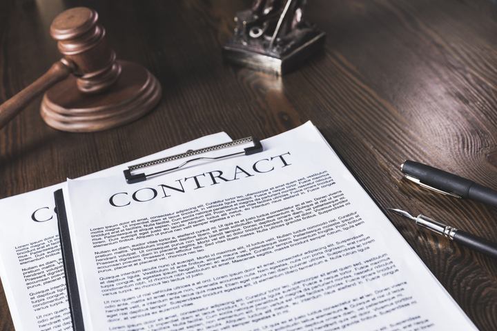 Franchise owner reviewing contract management documents to track key deadlines, legal obligations, and business agreements in Texas.