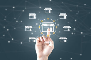 Hand connecting network of store icons