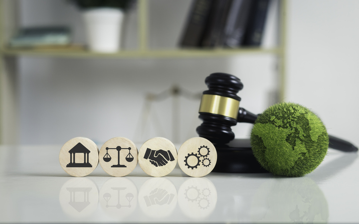 Symbols of justice, handshake, and green earth gavel.