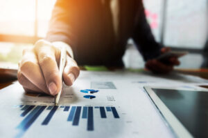 Person analyzing financial charts and graphs.