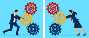 Businesspeople pushing interconnected gears.