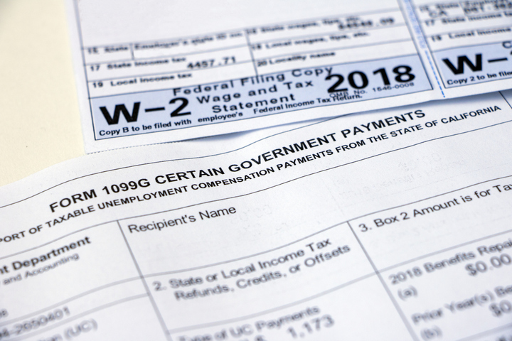 Tax forms W-2 and 1099G on table