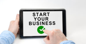 Tablet displaying 'Start Your Business' message.