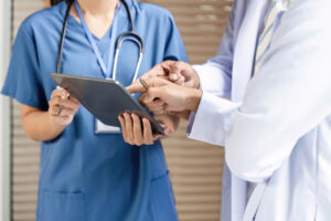Doctors reviewing patient information on tablet
